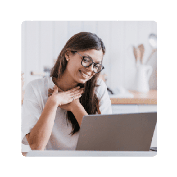 Grateful woman looking at laptop