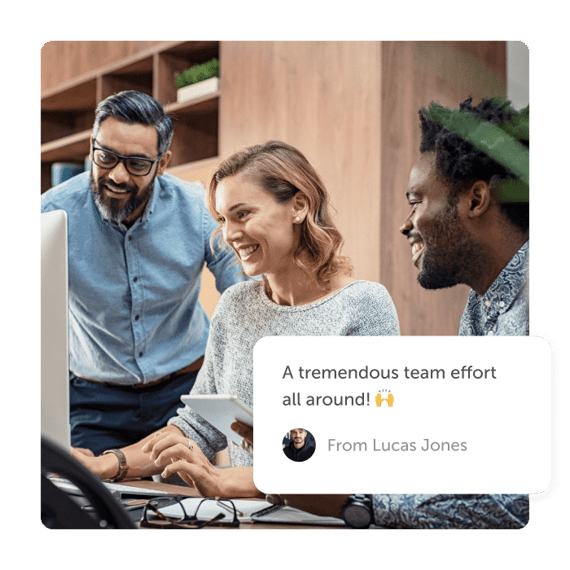 group of employees getting recognition board on desktop
