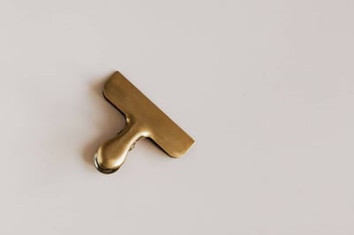 Gold clip sitting on white counter