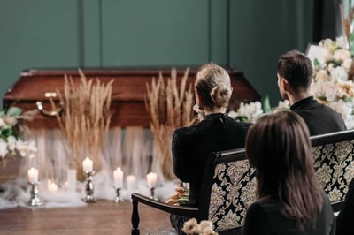 People sitting in rows at funeral