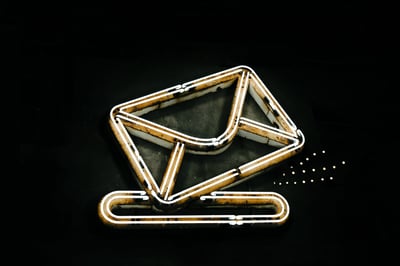 Neon sign of envelope against black background