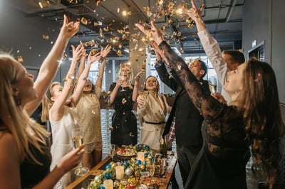 Employees at a virtual retirement party raising a glass
