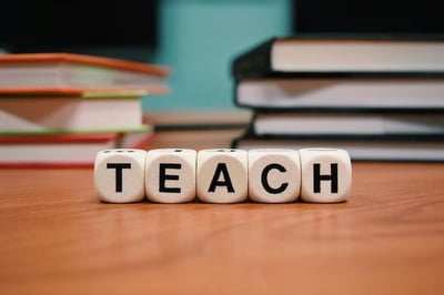 Blocks spelling the word "TEACH"