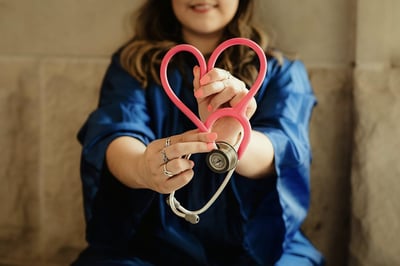 Nurse with stethoscope in a heart shape
