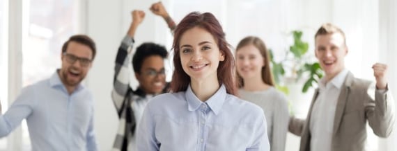 A team celebrating a woman at work