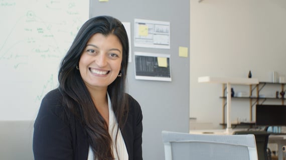 Human resources employee sitting at desk and smiling
