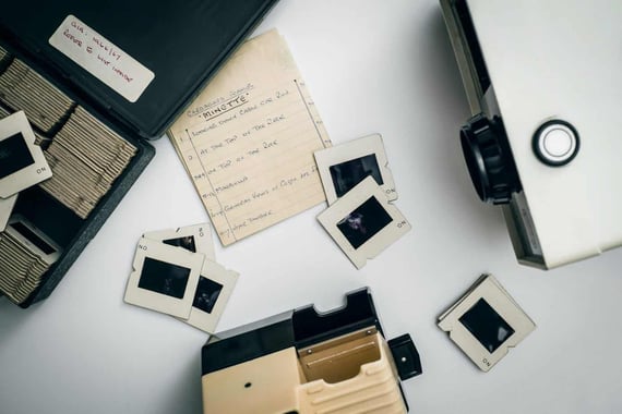 Slides, camera, and projector on table