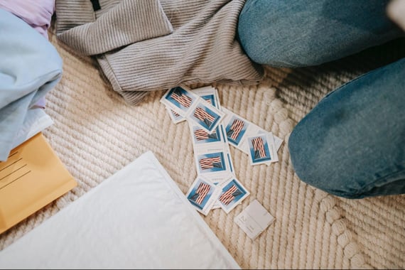 Postage stamps on floor with envelope