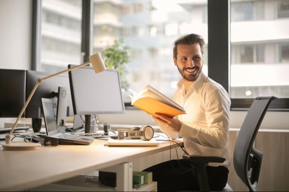 Employee engaging with notebook on desk