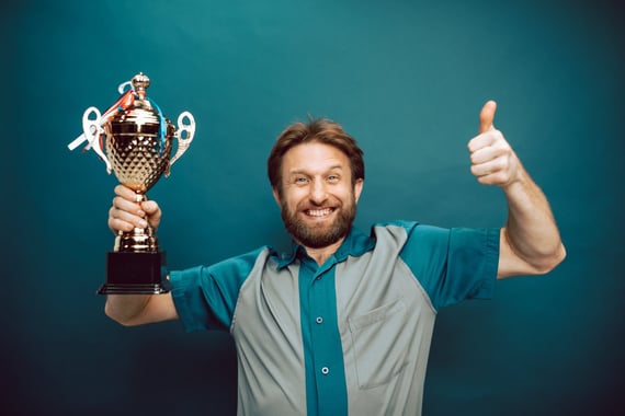 Employe with recognition award giving a thumbs up