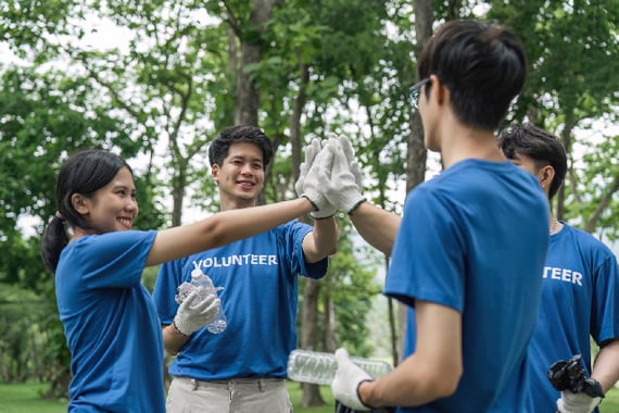 Earth Day volunteers cleaning up trash and high fiving