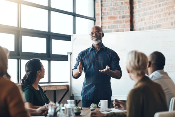 HR leader pitching employee appreciation ideas for large companies in meeting room