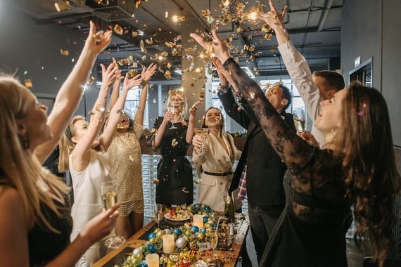 Employees at a virtual retirement party raising a glass