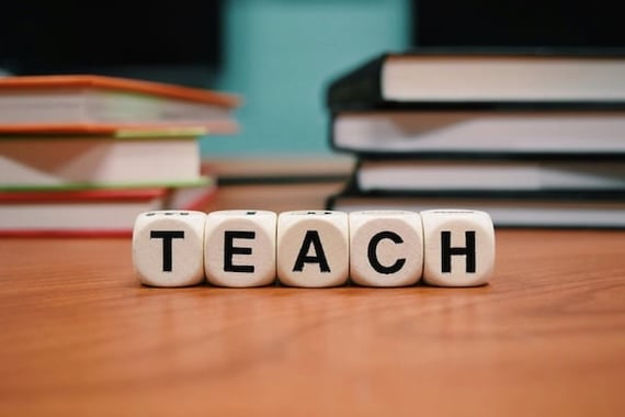 Blocks spelling the word "TEACH"
