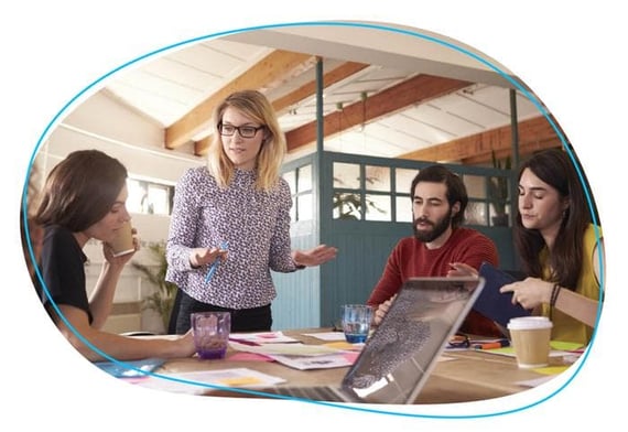 Boss working with employees around office table