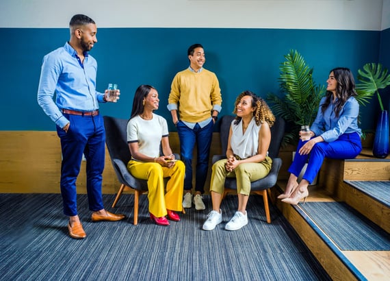 Office workers talking together in meeting room