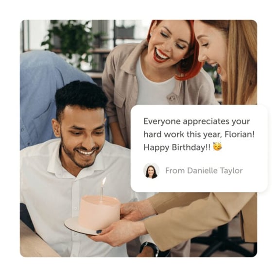 Office workers delivering cake with lit candle and a "happy birthday" post