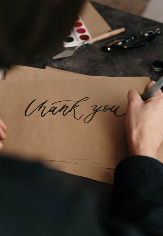 Hand writing thank you on card