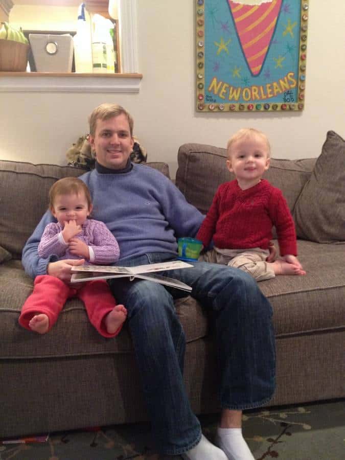 Man with two kids sitting on couch