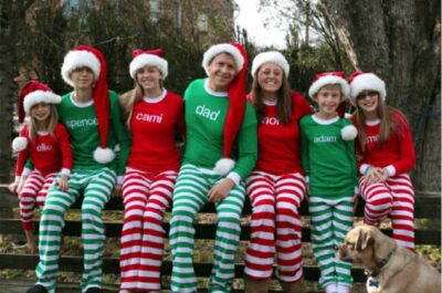 Family taking Christmas photo wearing matching outfits