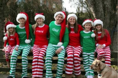 Family taking Christmas photo wearing matching outfits