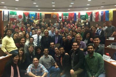 Large group of students in international room posing for photo