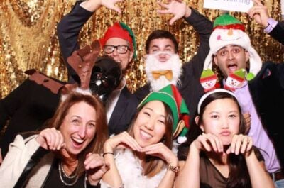 People in photo booth at company holiday party