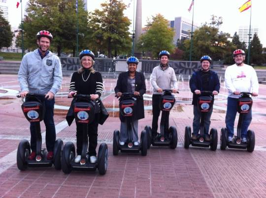 Group of people riding Segways