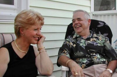 Couple laughing together in backyard