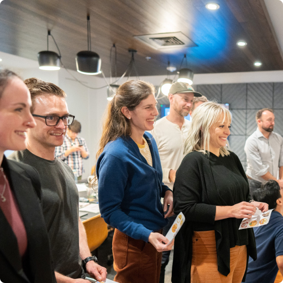 Kudoboard employees working together in meeting room