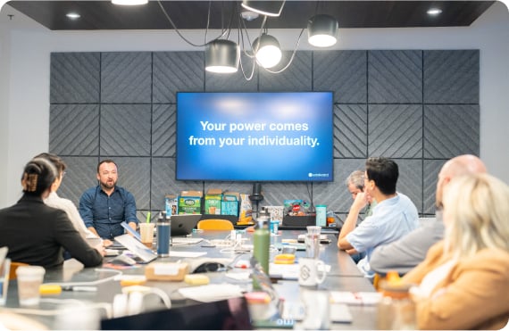 Kudoboard employee presenting in front of team