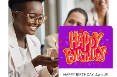 Smiling person holding cake and a happy birthday post