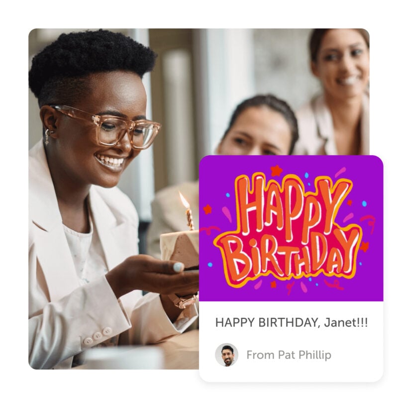 Smiling person holding cake and a happy birthday post