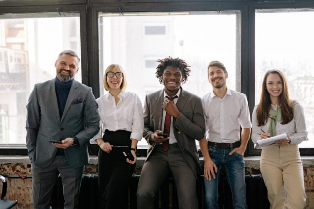 Group of employees standing together while giving shout outs