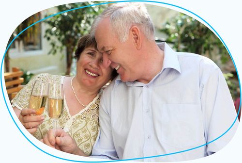 Older couple celebrating with champagne glasses
