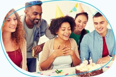 Group of people celebrating birthday with cake