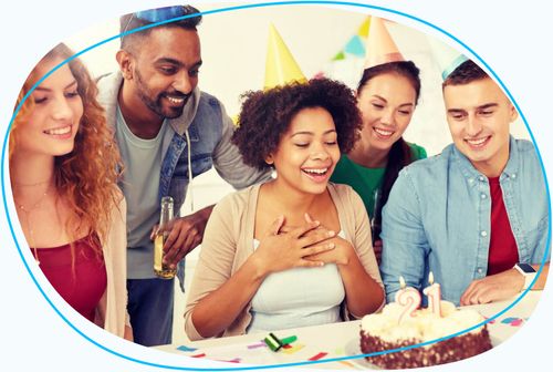 Group of people celebrating birthday with cake