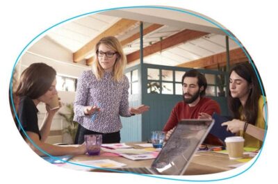 Boss working with employees around office table