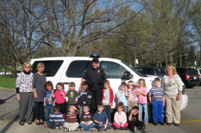 Children posing with police officer