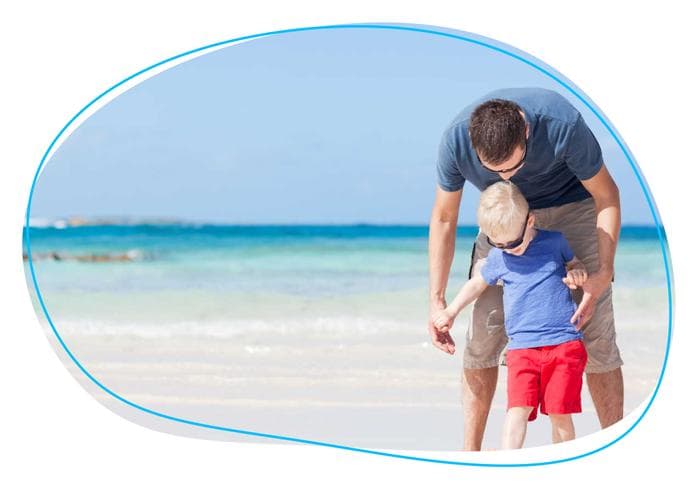 Father and son walking on beach