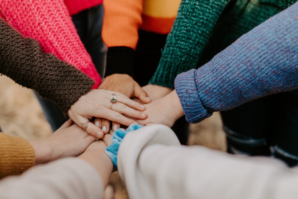 Group in circle placing hands in the middle
