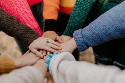 Group in circle placing hands in the middle