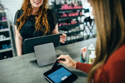 Person paying with card at front desk