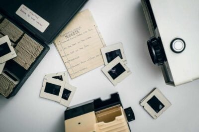 Slides, camera, and projector on table