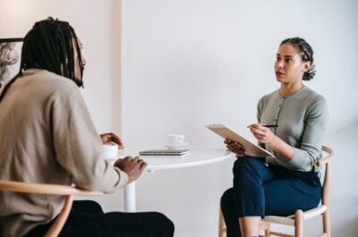 Person interviewing another person over coffee