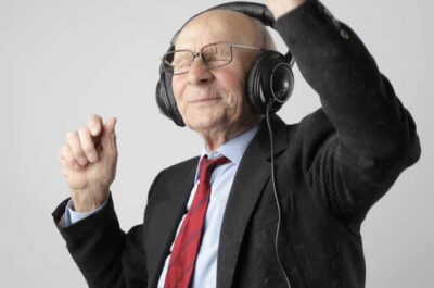 Older man dancing to music in headphones