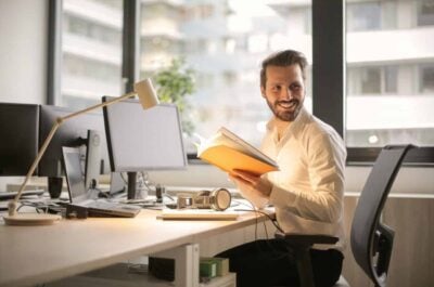 Man at desk smiling and looking back