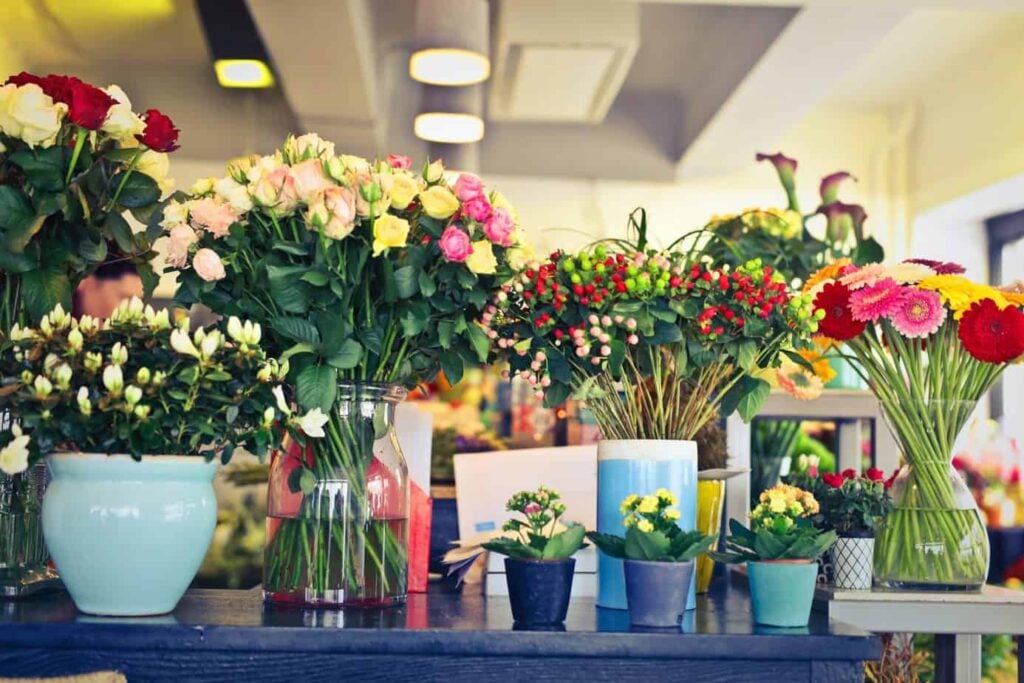 Vases of flower arrangements on table