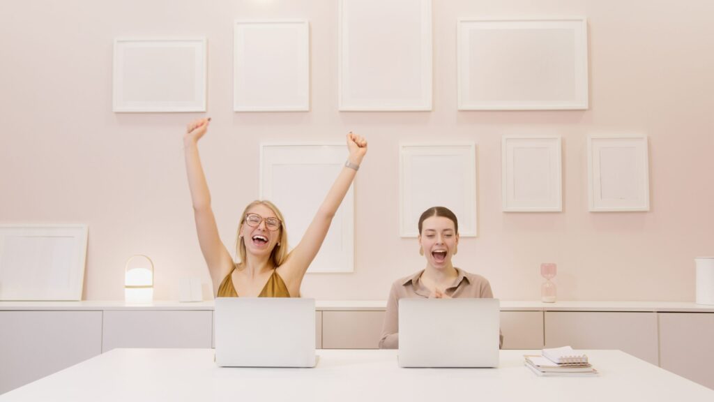 Celebrating employees in front of laptop