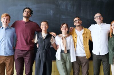 People in a row with arms on shoulders